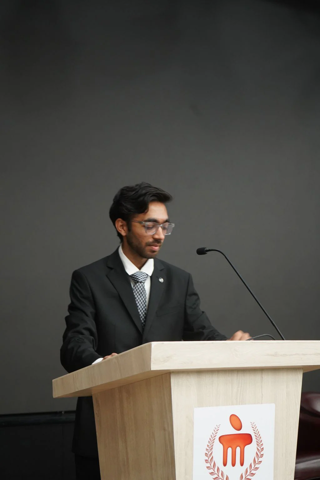 A speaker at a Manipal Institute of Technology lectern, from the HackSpace ’25 event photographs.